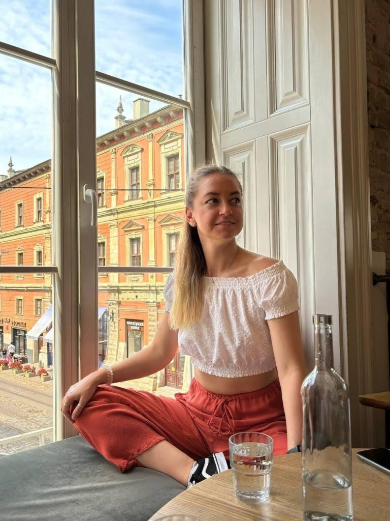 Business professional standing by office window