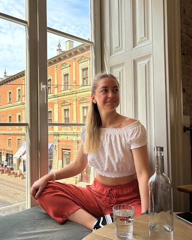 Business professional standing by window