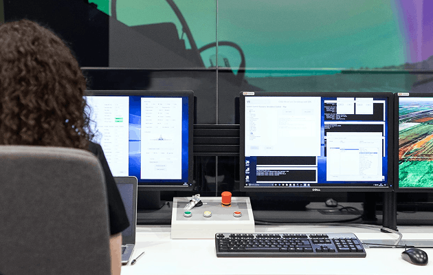Business software displayed on multiple computer screens
